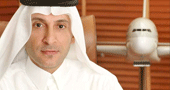 Akbar Al Baker with plane model in the background