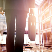 Image of a businessman carrying a briefcase   